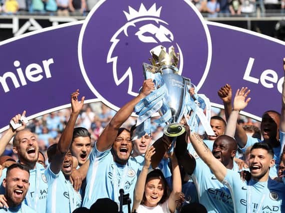 Manchester City lift the 2017/18 Premier League trophy.