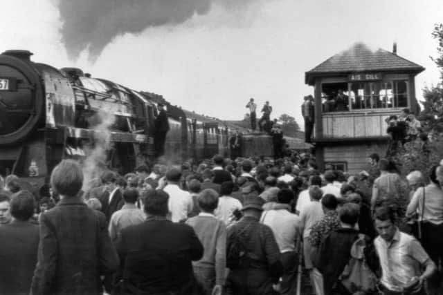 Thousands of people straining to get a look at Britain's last mainline steam passenger train as it passed through Rainhill station, between Liverpool and Manchester, in 1968