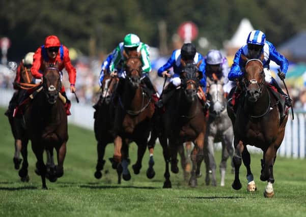 Battaash ridden by jockey Jim Crowley (right) comes home to win the King George Qatar Stakes at Goodwood, with Take Cover, left, coming home in second. Picture: Adam Davy/PA
