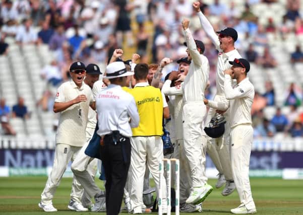 England's Adil Rashid is congratulated by captain Joe Root after taking the wicket of India's Ishant Sharma..