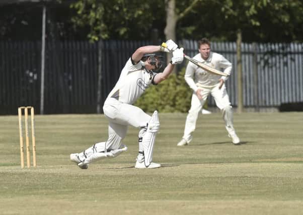In charge: 
Opener Mark Robertshaw on his way to 71 not out  for Pudsey St Lawrence to take them back to the top of the league at Townville. Picture: Steve Riding