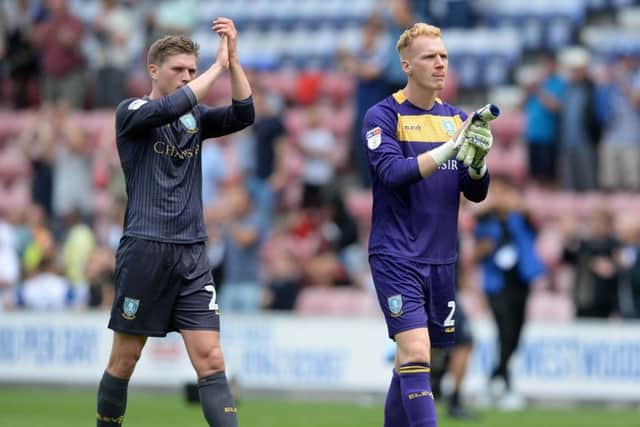 Adam Reach and Cameron Dawson at the final whistle after Wednesday's defeat to Wigan. (Picture: Steve Ellis)