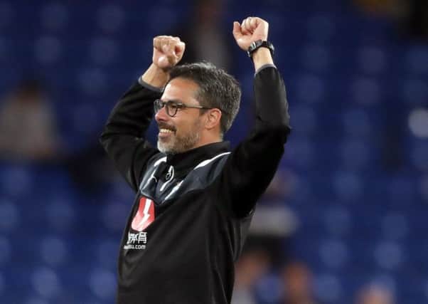 Staying up: Huddersfield Town coach David Wagner celebrates after the Premier League match at Stamford Bridge where a draw against Chelsea guaranteed safety.