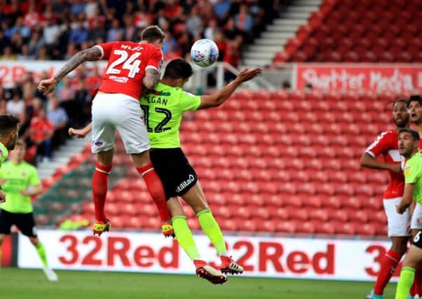 Middlesbroughs Aden Flint rises highest to head home Lewis Wings corner for the home sides second goal in their 3-0 Championship win over Sheffield United (Pictures: Owen Humphreys/PA Wire).
