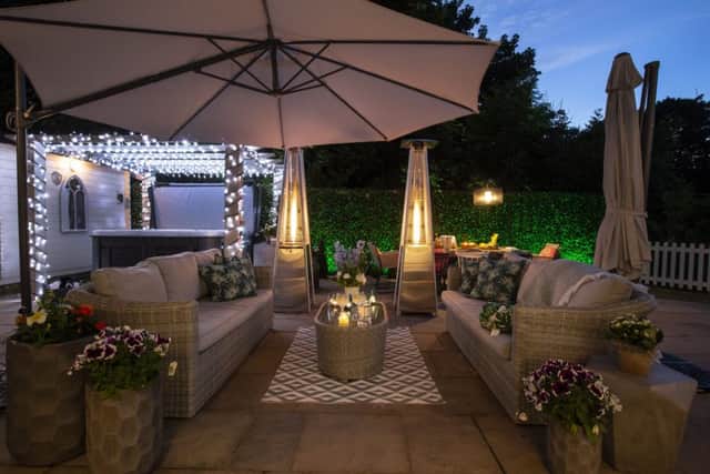 The outdoor room with sofas by Barker and Stonehouse.