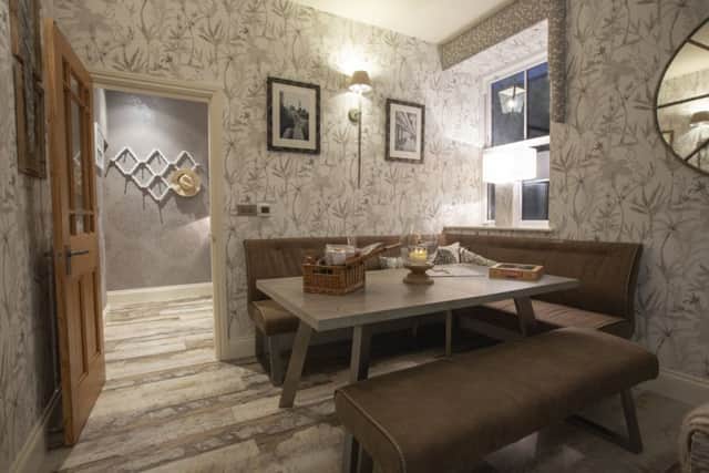 The dining area with fabric-backed wallpaper from Tektura