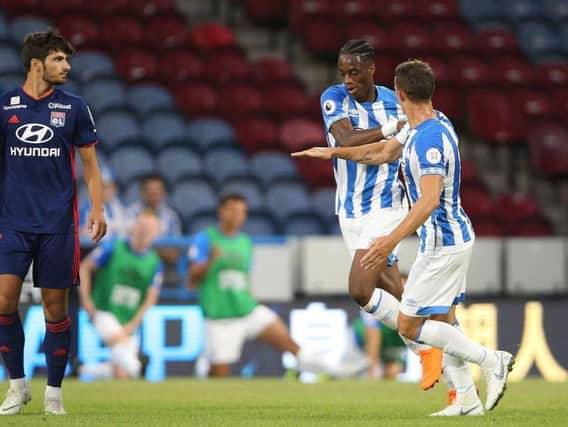 Huddersfield Town's Terence Kongolo (centre) celebrates scoring his side's first goal of the game against Lyon during a pre-season friendly match at the Kirklees Stadium, Huddersfield.