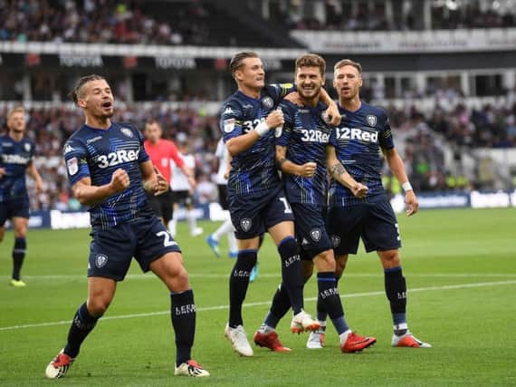 Leeds United players celebrate the opening goal at Pride Park.