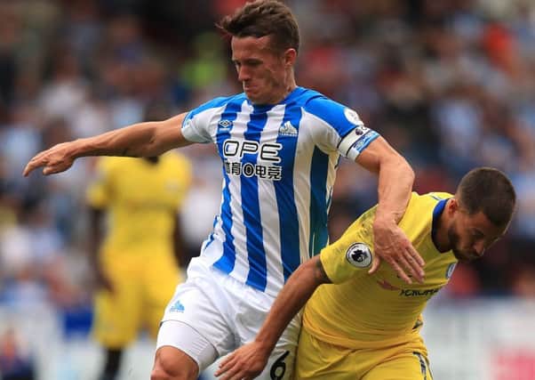 Battling: Huddersfield Town's Jonathan Hogg ) and Chelsea's Eden Hazard battle for the ball.