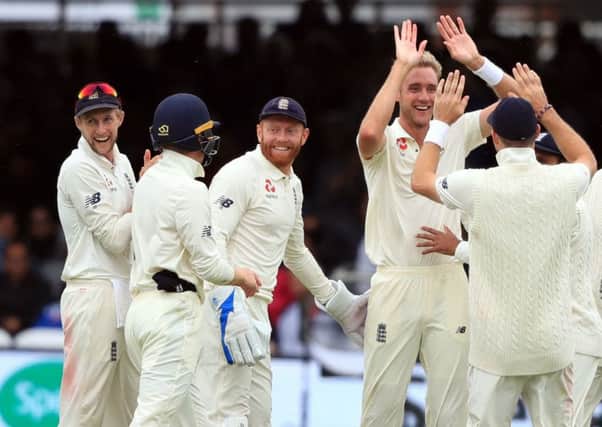 Englands Stuart Broad, second right, celebrates the wicket of Indias Dinesh Karthik as the hosts won by an innings and 159 runs in the second Test at Lords. Broad became the 10th highest Test wicket taker of all time during Sunday's play (Picture: Adam Davy/PA Wire).