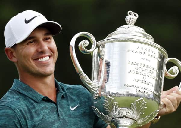 Champion smile: Brooks Koepka holds the Wanamaker Trophy after he won the PGA Championship.