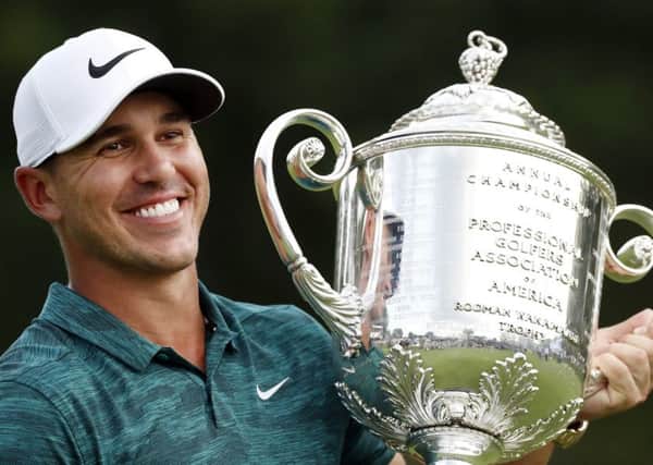 Brooks Koepka holds the Wanamaker Trophy after he won the PGA Championship golf tournament at Bellerive Country Club. (AP Photo/Brynn Anderson)