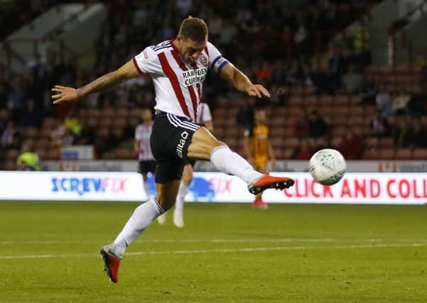 Unstoppable: Billy Sharp volleys home the equaliser for Sheffield United but it was Hull City who were happiest at the end, winning the Carabao Cup tie on penalties. (Picture: SportImage)