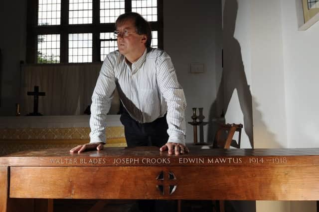 Robert Beaumont pictured by the alter showing the names of the soldiers who died in the Great War, at St Johns Church, Minskip. Picture by Simon Hulme