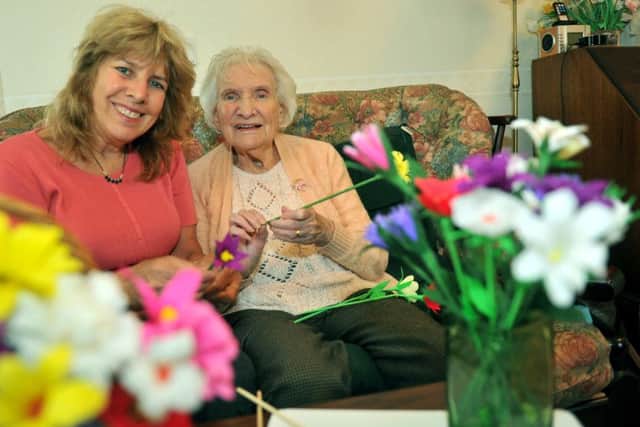 Margaret Reed, 88, making some paper flowers  at her home in Bedale with her daughter  Heather O'Neil
