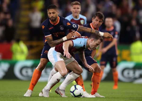 Istanbul Basaksehir's Emre (right) and Manuel da Costa battle for the ball with Burnley's Ashley Barnes.