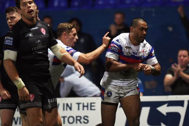 Wakefield's Bill Tupou celebrates scoring his side's third try.