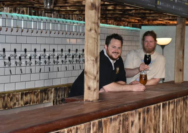 Brew Yorks co-founders Wayne Smith (left) and Lee Grabham (right), behind the bar of their new beer hall and street food kitchen in Walmgate. Picture by Ant Piercey.