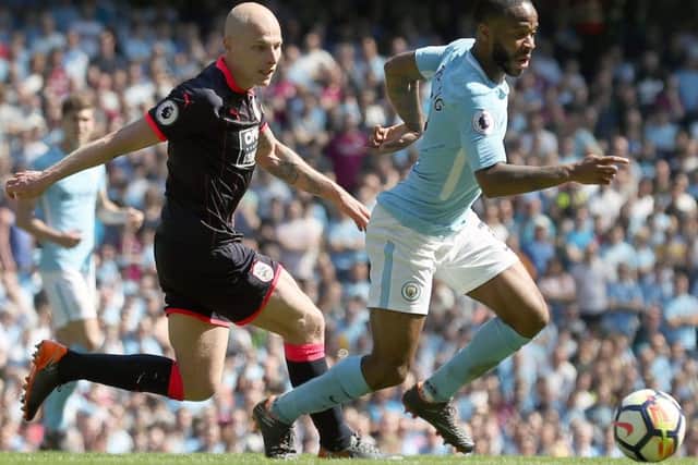 Manchester City's Raheem Sterling (right) and Huddersfield Town's Aaron Mooy battle for the ball during last year's Premier League game in which Town claimed an unlikely point (Picture: PA)