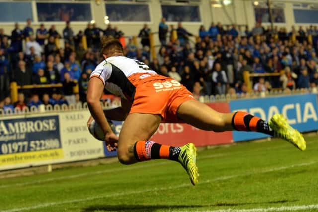 Greg Eden dives over the line to score the Tigers third try.