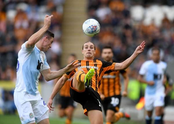 Jackson Irivine, of Hull City, kicks the ball away from Darragh Lenihan, of Blackburn Rovers.