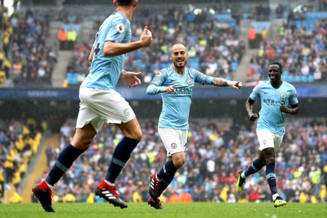 Manchester City's David Silva (centre) celebrates scoring his side's fourth goal of the game during the Premier League match at the Etihad Stadium, Manchester. (Pictures: PA)