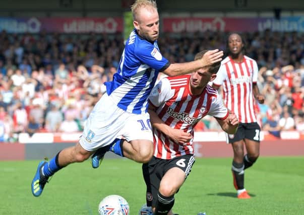 Sheffield Wednesday's Barry Bannan clashes with Brentford's Chris Mepham (Picture: Steve Ellis)