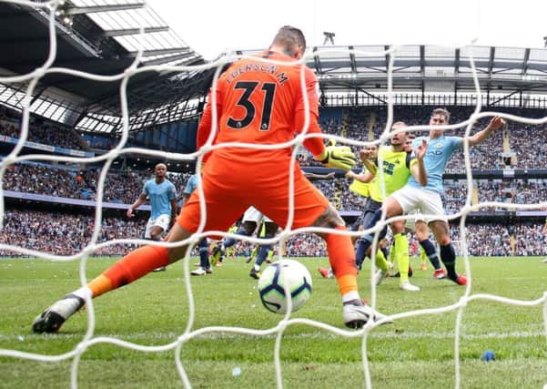 The ball rolls between Huddersfield Town goalkeeper Ben Hamers legs for Manchester City's first goal (Picture: Martin Rickett/PA Wire).