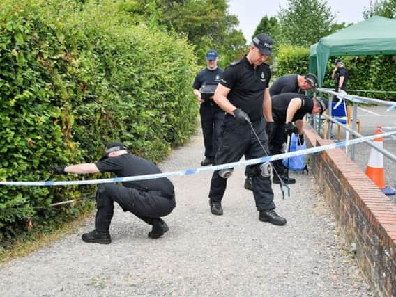 Police pictured last month conducting searches of Queen Elizabeth Gardens, Salisbury, where victim Dawn Sturgess visited before she died after coming into contact with Novichok. Photo: Ben Birchall/PA Wire