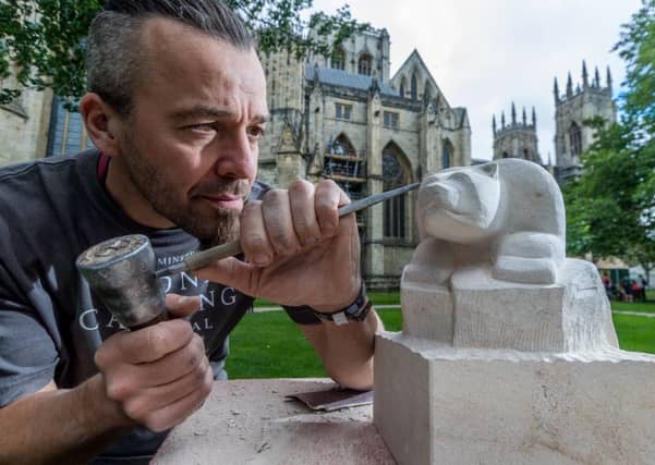 Yorkshire Minster Stonemason Richard Bossons, with his carving of a Polar Bear.