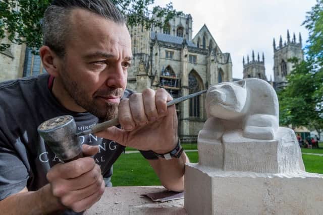 Yorkshire Minster Stonemason Richard Bossons, with his carving of a Polar Bear.