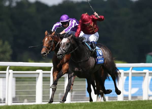 Roariong Lion and Oisin Murphy (maroon colours) outbattle Saxon Warrior in the Coral-Eclipse at Sandown.