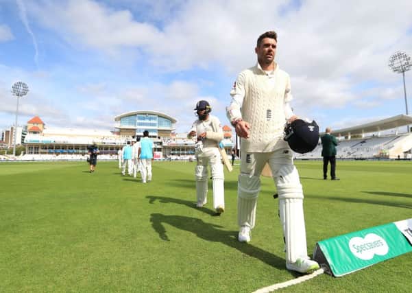 England's James Anderson walks off the pitch after defeat to India.