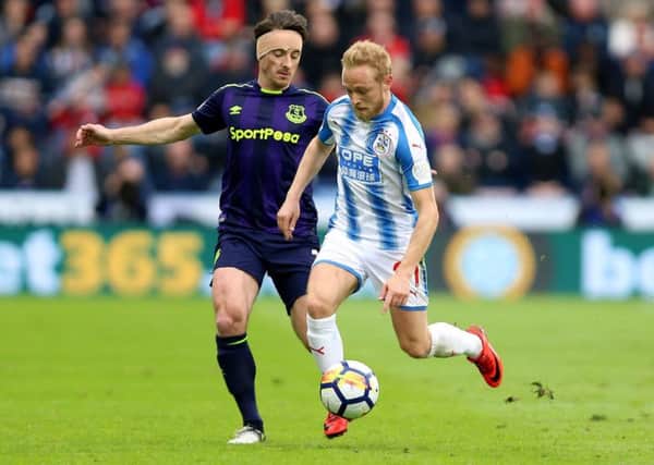 Huddersfield's Alex Pritchard tries to shackle Everton's Leighton Baines (Picture: PA)