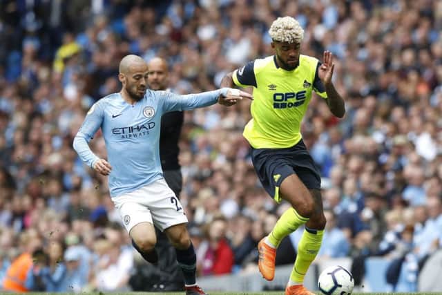 Huddersfield Town's Philip Billing (right) battle for the ball with Manchester City's David Silva (left) during the Terriers' heavy defeat to the champions (Picture: PA)