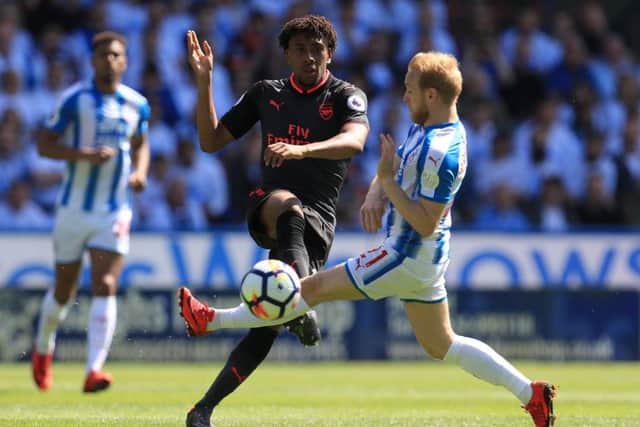 Arsenal's Alex Iwobi (left) and Huddersfield Town's Alex Pritchard in action during the Premier League match at the John Smith's Stadium, Huddersfield, last season. (Picture: PA)