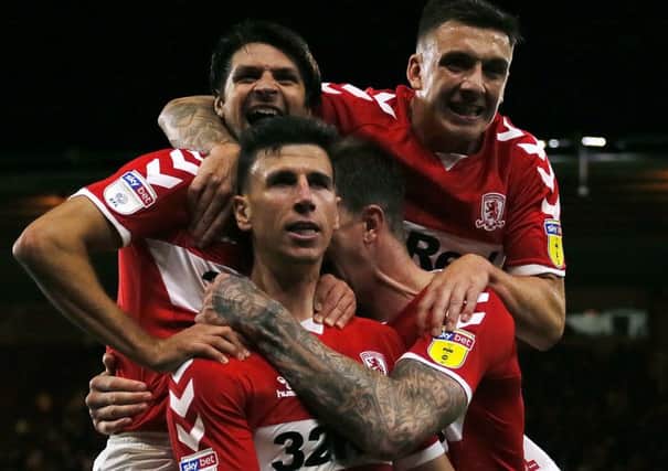 Late intervention: Spanish defender Daniel Ayala capped his first start of the season for Middlesbrough with the winning goal in the first minute of stoppage time, much to the delight of his team-mates. (Pictures: Richard Sellers/PA Wire)