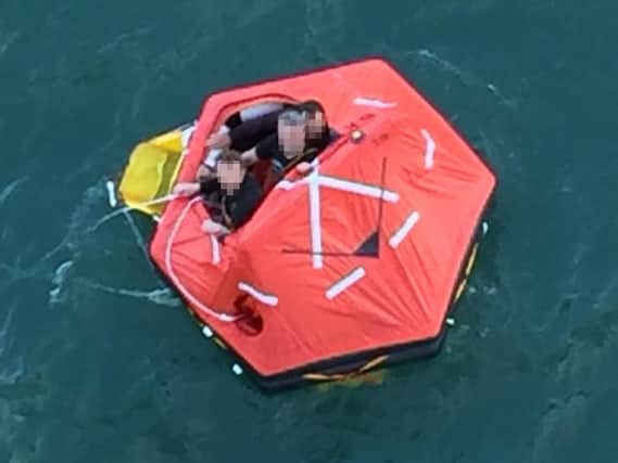 Three fishermen in a lifeboat who were rescued by crew from the Princess Cruise Lines' Pacific Princess as they drifted in the North Sea off the English coast. PIC: Alexandra Rosen/PA Wire