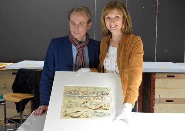 Philip Mould and Fiona Bruce of Fake Or Fortune? with the sketch by Yorkshire sculptor Henry Moore. PIC: BBC/PA.