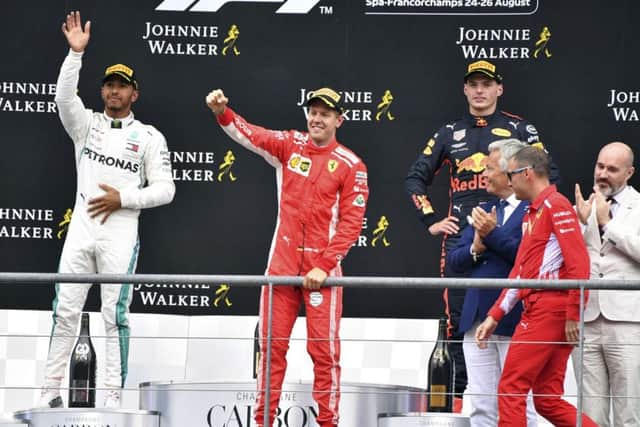 Ferrari driver Sebastian Vettel of Germany, center, jubilates on the podium alongside runner-up Lewis Hamilton and third-placed Max Verstappen. Picture: AP/Geert Vanden Wijngaert