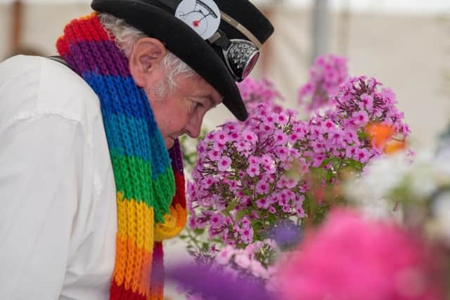 Mel Wynn, of Grassington, admiring a vase of Phlox at Kilnsey Show. Pictures by James Hardisty.