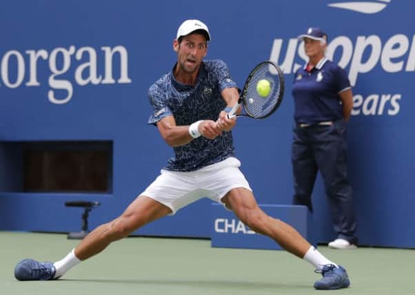 STRETCHED: Serbias Novak Djokovic returns a shot to Hungarys Marton Fucsovics, who he defeated in four sets. (Picture: Frank Franklin II/AP)