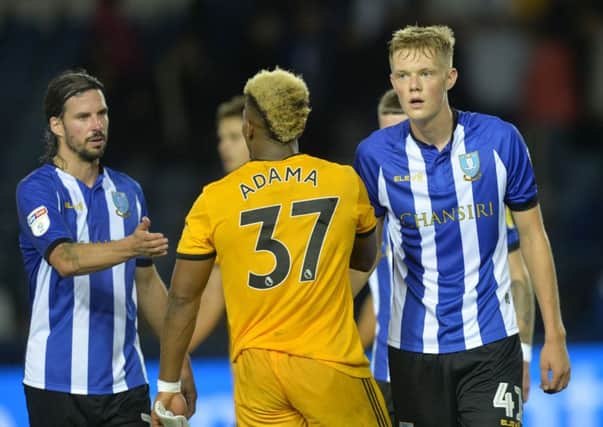 Home bow: Wolves danger man Adama Traore with Owls pair George Boyd and young Jack Lee. Picture: Steve Ellis