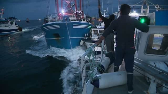 French maritime authorities are appealing for calm after fishermen from rival French and British fleets banged their boats in ill-tempered skirmishes over access to the scallop-rich waters off France's northern coast. (France 3 via AP)