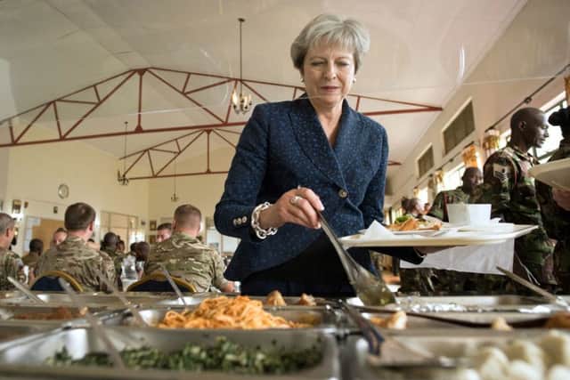 Prime Minister Theresa May joins British soldiers for lunch at the Embakasi Counter IED centre in Nairobi, where she saw mine detection training by both British and Kentan military, on the third day of her visit to Africa. PIC: PA