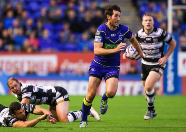Warrington's Stefan Ratchford breaks the attempted tackle by Hull FC's Carlos Tuimavave. Picture: Alex Whitehead/SWpix.com