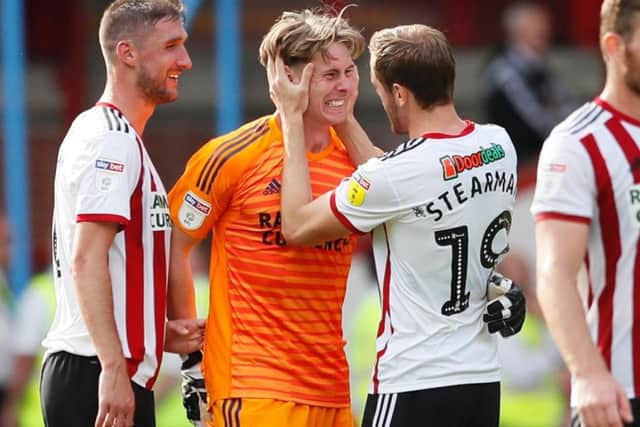 United goalkeeper Dean Henderson celebrates with Richard Stearman and Chris Basham after the Blades' win over Norwich City. (Picture: Simon Bellis - SportImage)