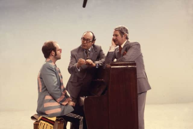 Elton John at the piano with Eric Morecambe and Ernie Wise.