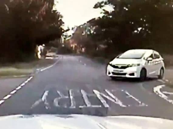 The moment the driver almost took out a police patrol car. Photo: SWNS