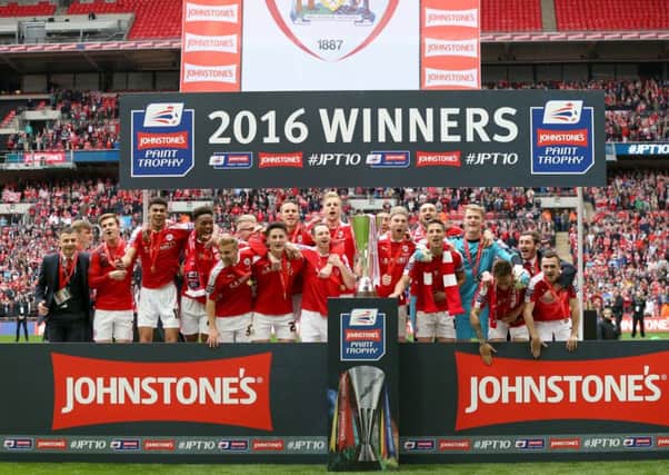 HAPPY DAYS: Barnsley players celebrate with the Johnstone's Paint Trophy  at Wembley in  April 2016. Picture: Adam Davy/PA.